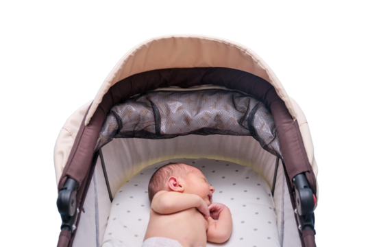 Baby boy in a carriage, isolated on a white background. A child in white clothes in only diapers is lying in a stroller, studio shot