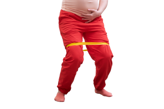 A pregnant woman does sports at home and does exercises with an elastic band for stretching legs, isolated on a white background