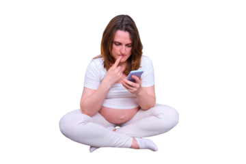 Pregnant woman thoughtfully looks at the phone in the home, isolated on a white background