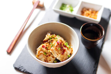 Steamed dumpling stuffed ground shrimp and pork dipping sweet chili sauce with fried garlic and spring onions.