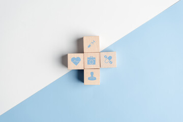 Health insurance concept. plus symbol and healthcare medical wooden cube block with icon, health...