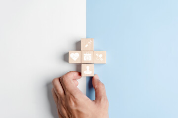 Health insurance concept. people hands putting plus symbol and healthcare medical wooden cube block with icon, health and access to welfare health concept..