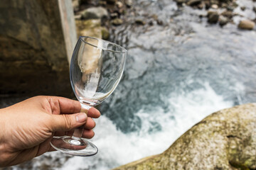 The beauty of nature is discovered through our stunning wine glass mockup images, featuring a transparent blank wine glass and a natural background