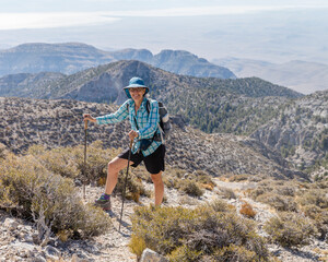 Front view of a female hiker on her way to the top of Notch Peak.