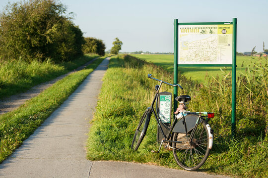 Vintage and black bike standing by junction indicator with map, Groningen, Netherlands