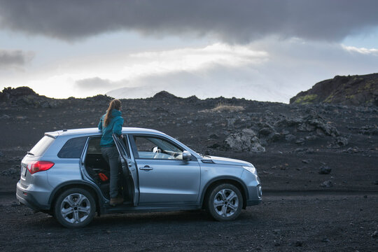 Woman peering out of SUV, Heckla, Iceland