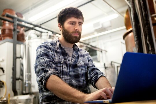 Man with laptop in brewery