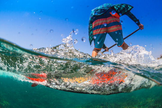 Sup surfing in tropical water.