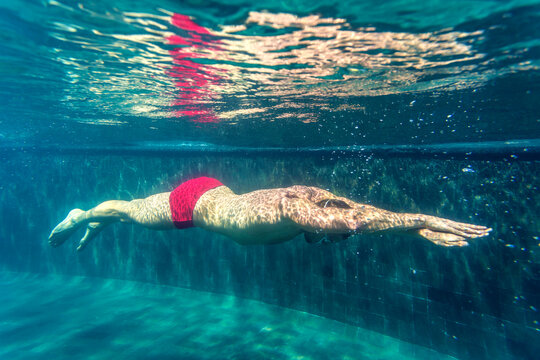 Swimmer  In Pool. Under Water Shot.