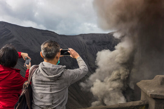 Hikers standing on top of the mountain and taking a pictures,Java,Indonesia.