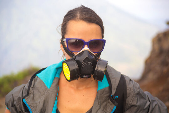 Young woman in gas mask,volcano Ijen,Java,Indonesia
