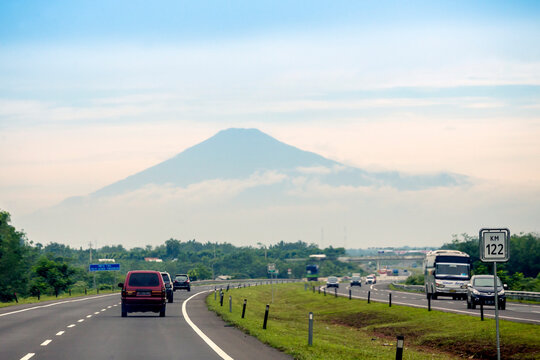 Curve Road View With Volcano At Background In Java, Indonesia