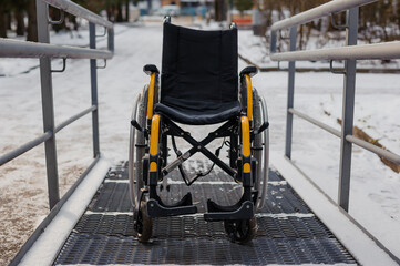 Empty wheelchair in the hospital on the ramp. Wheelchair close-up. Children's wheelchair
