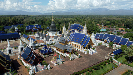 Wide-angle shot from a drone at Ban Den Temple, Chiang Mai Province, in Thailand, is an ancient temple. but has been taken care of and restored to be beautiful and is a landmark of tourists and people