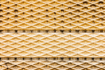 Repetitive abstract tiles on wall