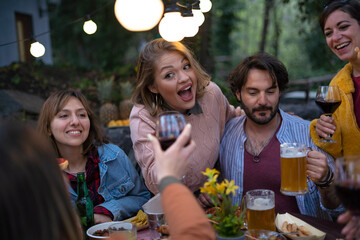 Rustic countryside background where a group of Caucasian friends toasting and celebrating during happy hour