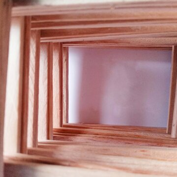wooden spatula sticks arranged like room. handycrafts. miniature. creative. kapla. close up of room. minimalist. wooden frame on wood wall