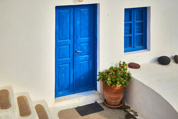 Fototapeta na wymiar Dark Blue front door to a house in an old minimalist Greek village 