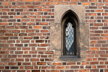 Fototapeta na wymiar Gothic window to the temple. Curved arch - the most characteristic features of Gothic.