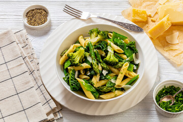 Pasta primavera with green veggies, cheese in bowl