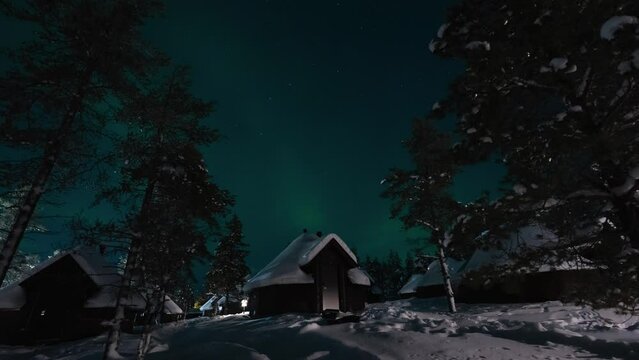 time-lapse of aurora borealis on top of igloo hotel