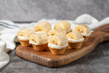 Banana tartlet. Delicious tartlet dessert on wood serving board. close up