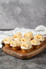 Banana tartlet. Delicious tartlet dessert on wood serving board. close up