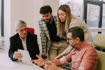 A close up photo of four colleagues working together