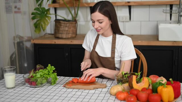 Woman preparing salad in the kitchen and healthy  food in bowl at home