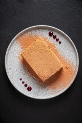 tiramisu cake on the black background