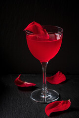 cocktail with rose syrup on dark background