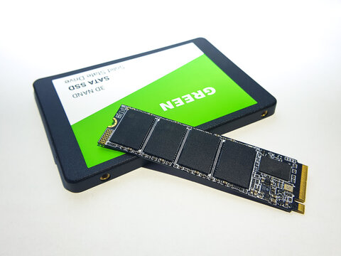 Computer parts NVME SSD and SATA SSD on white background in 2023