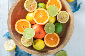 Fototapeta na wymiar Tasty and fresh mix of citrus fruits in wooden bowl.
