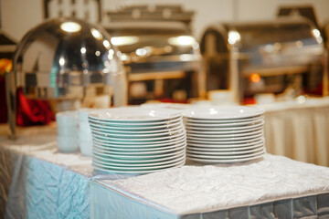 Trays, plates, cutlery on a table in catering service