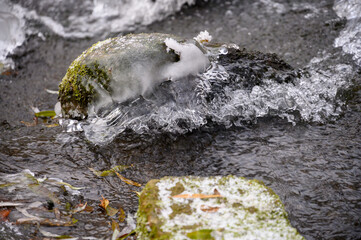 plätscherndes Wasser mit Eis bedeckt
