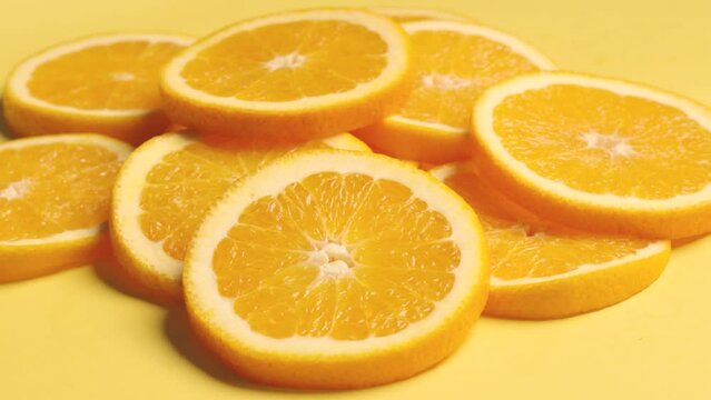 sliced orange on orange background, turn shot 