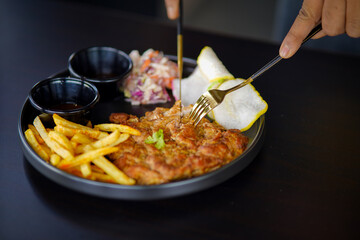 Grilled chicken breast, French fries and vegetables stock photo