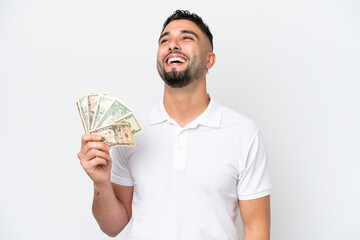 Young Arab man taking a lot of money isolated on white background laughing