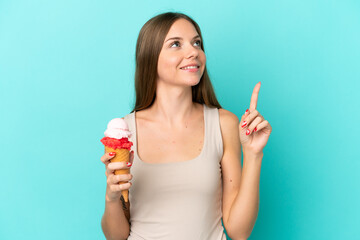 Young Lithuanian woman with cornet ice cream isolated on blue background pointing up a great idea