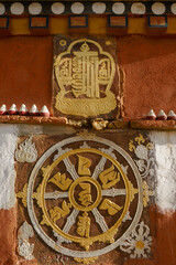 Closeup view of buddhist votive stone with mantra carving on a prayer wall in Paro, Bhutan