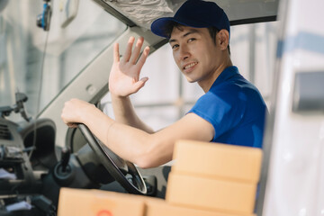 Fototapeta na wymiar Asian delivery man, driver with the parcel on the seat outside the warehouse.