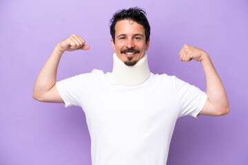 Young caucasian man wearing neck brace isolated on purple background doing strong gesture