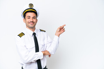 Airplane pilot over isolated white background pointing finger to the side