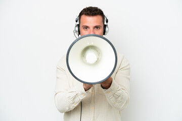 Telemarketer caucasian man working with a headset isolated on white background shouting through a megaphone