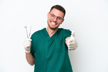 Young caucasian dentist man isolated on white background shaking hands for closing a good deal