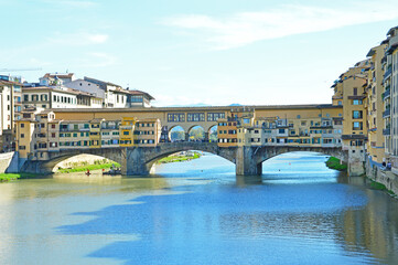 Ponte Vecchio is a medieval stone bridge on the Arno river in Fl