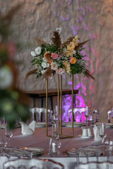 Boho wedding decor. Wedding centerpieces arrangements with dried flowers floristry and candles, boho style.