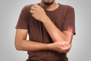 A man elbow bone ache, People suffering from pain in cubit on a gray background. Diseases of the elbow joint. Osteoarthritis - obrazy, fototapety, plakaty