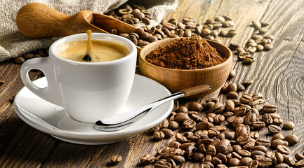 Coffee cup and beans on old wooden table.