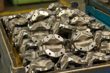 The freshly prepared parts of the driveshaft of the truck are stacked in a box